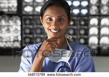 Portrait of female doctor with hand on chin View Large Photo Image Stock Photo - Portrait of female doctor with hand on chin. Fotosearch