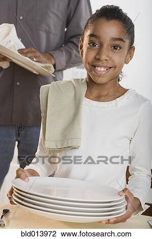 Portrait of girl drying dishes with father View Large Photo Image Stock Image - Portrait of girl drying dishes with father. Fotosearch