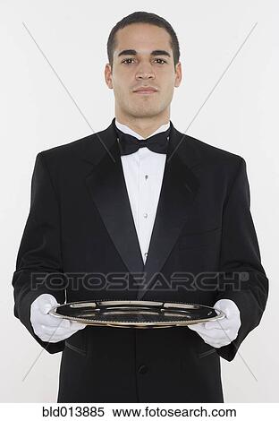Portrait of male waiter holding tray View Large Photo Image Stock Photography - Portrait of male waiter holding tray. Fotosearch