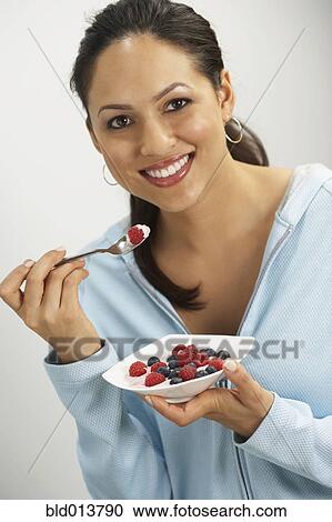 Portrait of woman eating bowl of fruit View Large Photo Image Stock Image - Portrait of woman eating bowl of fruit. Fotosearch