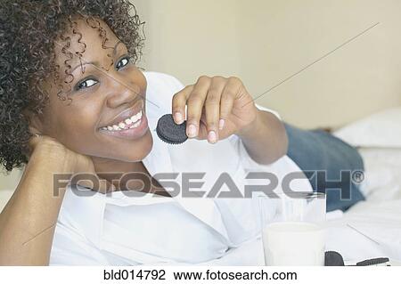 Portrait of woman eating cookies and milk View Large Photo Image Stock Image - Portrait of woman eating cookies and milk. Fotosearch