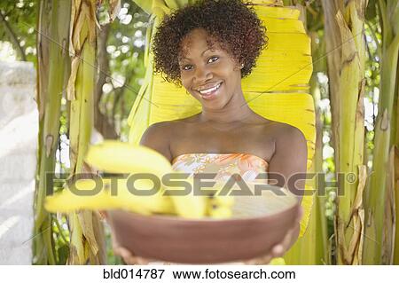 Portrait of woman holding bowl of bananas View Large Photo Image Stock Photo - Portrait of woman holding bowl of bananas. Fotosearch