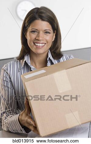Portrait of woman holding box View Large Photo Image Stock Photography - Portrait of woman holding box. Fotosearch