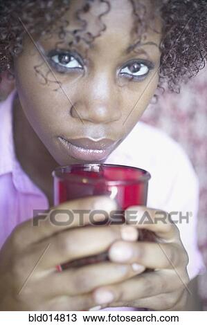Stock Image - Portrait of woman holding coffee cup. Fotosearch