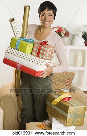 Portrait of woman holding gifts and wrapping paper View Large Photo Image Stock Photo - Portrait of woman holding gifts and wrapping paper. Fotosearch