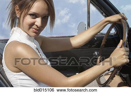Portrait of woman sitting in convertible View Large Photo Image Stock Photograph - Portrait of woman sitting in convertible. Fotosearch