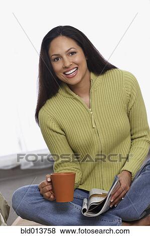 Portrait of woman sitting on floor with coffee and magazine View Large Photo Image Stock Photo - Portrait of woman sitting on floor with coffee and magazine. Fotosearch