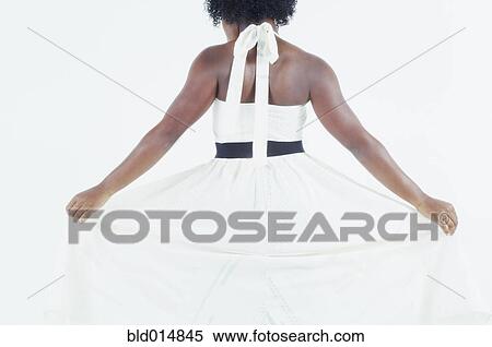 Rear view of woman fanning out skirt of white dress View Large Photo Image Stock Photography - Rear view of woman fanning out skirt of white dress. Fotosearch