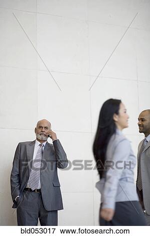 Stock Photo - Senior African businessman talking on cell phone. Fotosearch