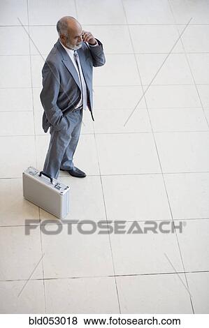 Senior African businessman talking on cell phone View Large Photo Image Stock Photo - Senior African businessman talking on cell phone. Fotosearch