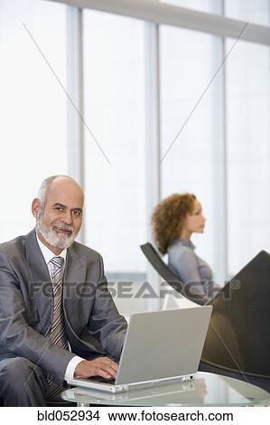 Senior African businessman typing on laptop View Large Photo Image Picture - Senior African businessman typing on laptop. Fotosearch