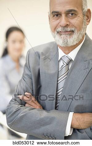 Stock Image - Senior African businessman with arms crossed. Fotosearch