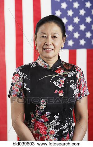 Senior Asian woman standing in front of American flag View Large Photo Image Stock Image - Senior Asian woman standing in front of American flag. Fotosearch