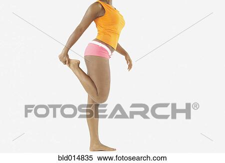 Side view of lower section of woman stretching View Large Photo Image Stock Photography - Side view of lower section of woman stretching. Fotosearch