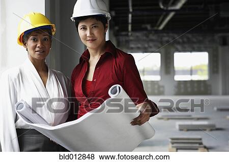 Stock Photo - Two women at construction site. Fotosearch