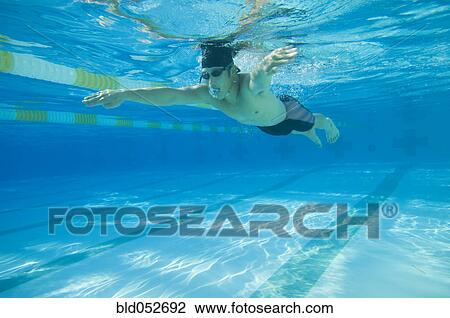 Underwater shot of Asian man swimming View Large Photo Image Stock Image - Underwater shot of Asian man swimming. Fotosearch