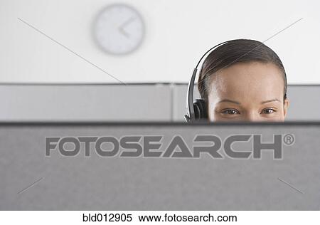 Stock Photography - Upper section of woman's head in office. Fotosearch