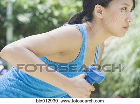 Woman exercising with dumbbell View Large Photo Image Stock Image - Woman exercising with dumbbell. Fotosearch