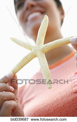 Woman holding starfish View Large Photo Image Stock Photo - Woman holding starfish. Fotosearch