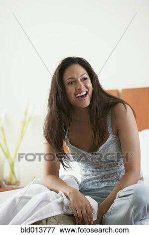 Woman in bed laughing View Large Photo Image Stock Photo - Woman in bed laughing. Fotosearch
