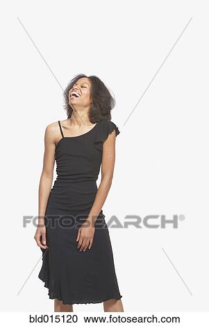 Woman in black gown laughing View Large Photo Image Stock Image - Woman in black gown laughing. Fotosearch