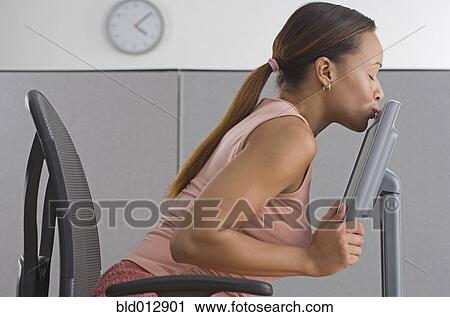 Woman in office kissing computer monitory View Large Photo Image Stock Image - Woman in office kissing computer monitory. Fotosearch