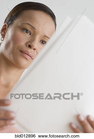 Stock Photograph - Woman reading papers. Fotosearch