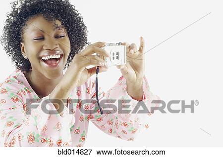 Woman taking self-portrait with camera View Large Photo Image Stock Photo - Woman taking self-portrait with camera. Fotosearch
