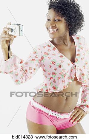 Woman taking self portrait with camera View Large Photo Image Stock Photo - Woman taking self portrait with camera. Fotosearch