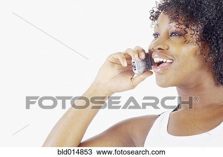 Stock Image - Woman talking on cell phone. Fotosearch