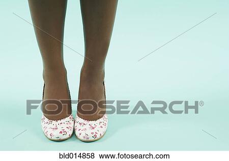 Stock Photo - Woman's lower legs and feet in high heels. Fotosearch