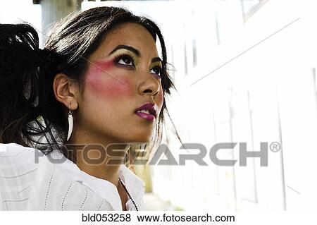 Stock Photo - Young Asian woman wearing dramatic makeup. Fotosearch