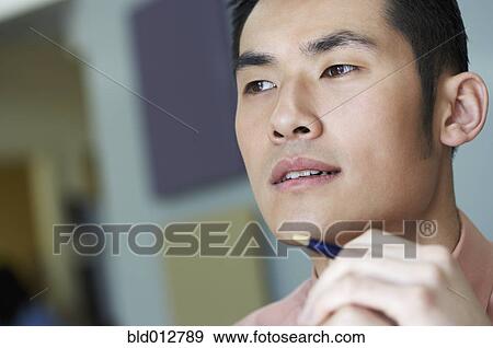 Young man looking pensive View Large Photo Image Stock Photo - Young man looking pensive. Fotosearch