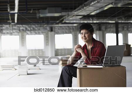 Young woman sitting in construction site View Large Photo Image Stock Image - Young woman sitting in construction site. Fotosearch