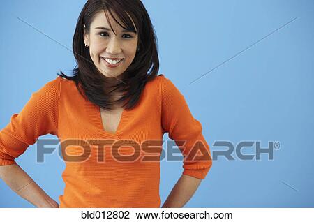 Young woman smiling at camera View Large Photo Image Stock Image - Young woman smiling at camera. Fotosearch
