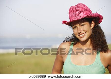 Young woman wearing hat at beach View Large Photo Image Stock Photo - Young woman wearing hat at beach. Fotosearch