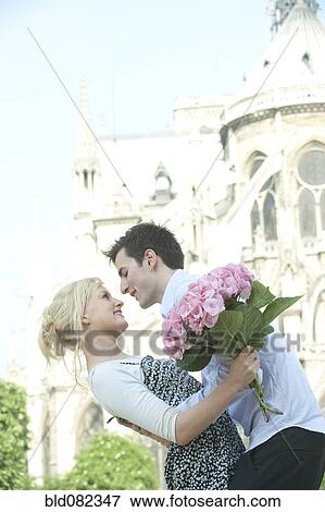 Caucasian couple about to kiss near historical landmark near Notre Dame View Large Photo Image Stock Photo - Caucasian couple about to kiss near historical landmark near Notre Dame. Fotosearch