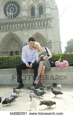Caucasian couple feeding pigeons near Notre Dame View Large Photo Image Stock Image - Caucasian couple feeding pigeons near Notre Dame. Fotosearch