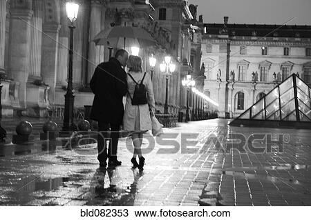 Caucasian couple kissing in rain at night at the Louvre View Large Photo Image Stock Image - Caucasian couple kissing in rain at night at the Louvre. Fotosearch