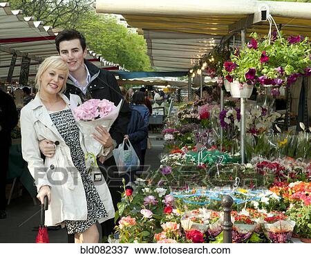 Stock Photo - Caucasian couple shopping in market. Fotosearch