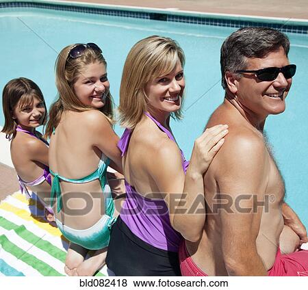 Caucasian family sitting near swimming pool View Large Photo Image Stock Photo - Caucasian family sitting near swimming pool. Fotosearch