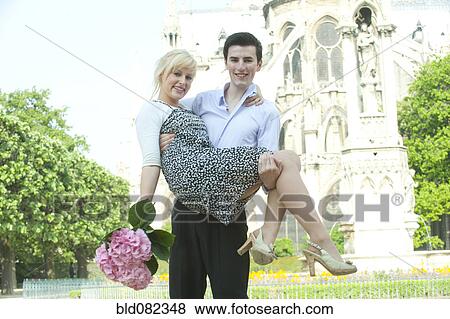 Caucasian man carrying girlfriend near Notre Dame View Large Photo Image Stock Photo - Caucasian man carrying girlfriend near Notre Dame. Fotosearch