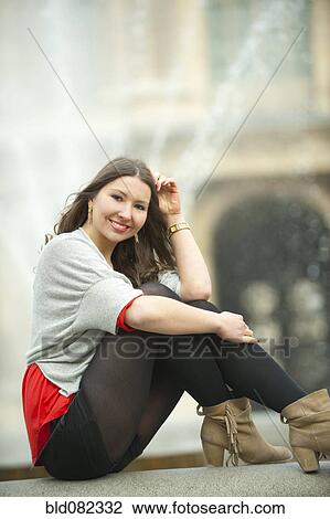 Caucasian woman sitting near fountain View Large Photo Image Stock Image - Caucasian woman sitting near fountain. Fotosearch