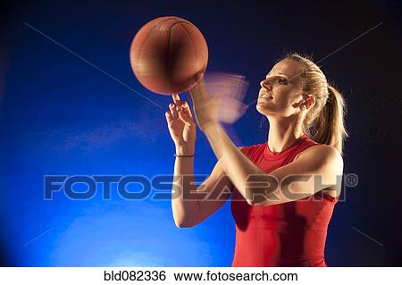 Caucasian woman spinning basketball View Large Photo Image Stock Photograph - Caucasian woman spinning basketball. Fotosearch