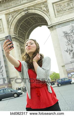 Caucasian woman taking self-portrait near Arc de Triomphe View Large Photo Image Stock Photo - Caucasian woman taking self-portrait near Arc de Triomphe. Fotosearch
