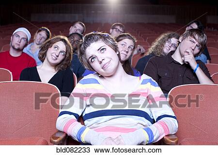 Caucasian woman watching movie in theater View Large Photo Image Stock Image - Caucasian woman watching movie in theater. Fotosearch