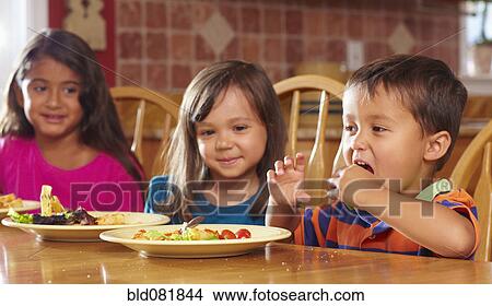 Children eating dinner at table together View Large Photo Image Picture - Children eating dinner at table together. Fotosearch