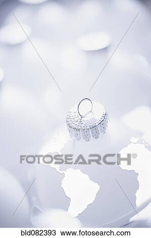 Stock Image - Christmas ornament shaped like globe. Fotosearch