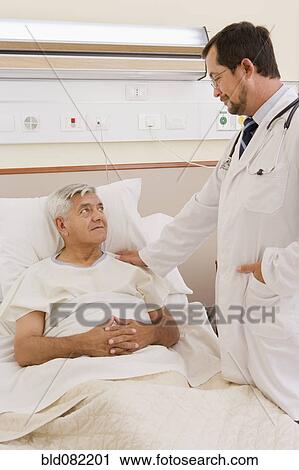 Doctor talking with patient in hospital room View Large Photo Image Stock Image - Doctor talking with patient in hospital room. Fotosearch
