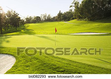 Flag on golf course surrounded by sand traps View Large Photo Image Stock Image - Flag on golf course surrounded by sand traps. Fotosearch